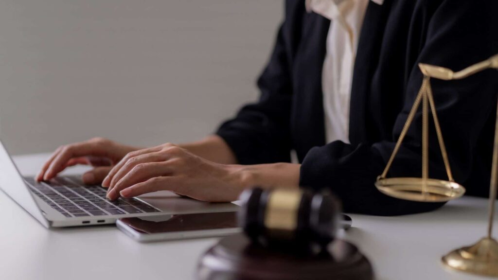 A lawyer typing content on their laptop for their personal injury service pages