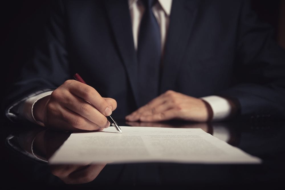 A personal injury attorney writing content on a paper with a pen
