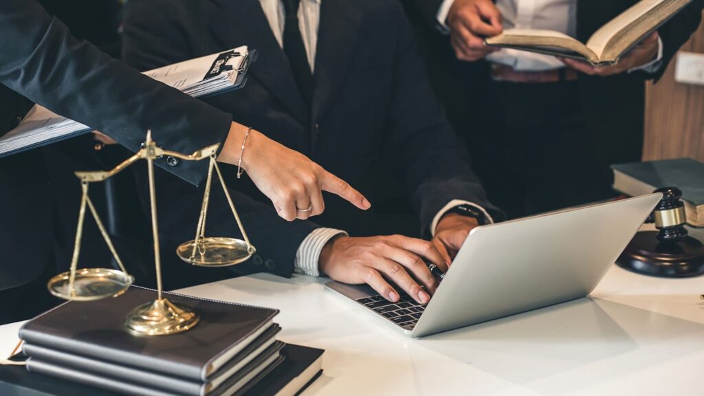 A couple of personal injury lawyers on a laptop doing their on-page SEO