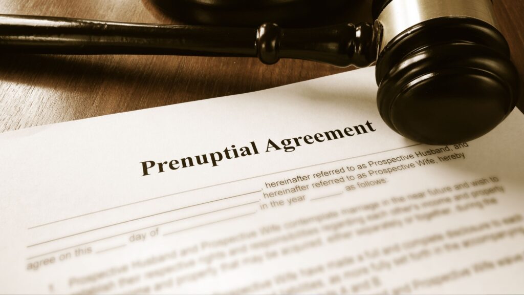 A prenuptial agreement and a gavel sitting on a lawyer's desk